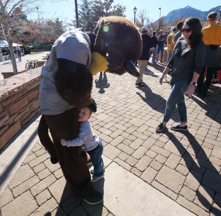 Chip greets a young fan during Homecoming weekend on the CU Boulder campus on Saturday, Nov. 9, 2019. (Photo by Glenn Asakawa/University of Colorado)