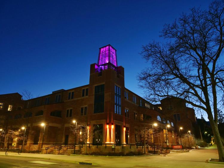 On March 5, the Roser ATLAS building shines magenta––part of the state of Colorado's COVID-19 anniversary remembrance. (Photo by Glenn Asakawa/CU Boulder)