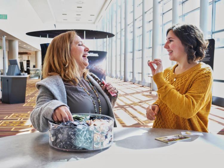 California high school senior Kendall Mata shows an "I'm an Art Buff" pin to her mother Sherry Marshall at the CU Boulder Next event at LA Live. Photo by Glenn Asakawa.