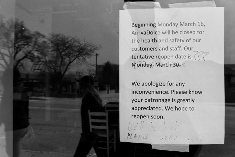 Sign announces business closing due to COVID-19 with tentative reopening date of March 30, later scratched out with pen and question marks.