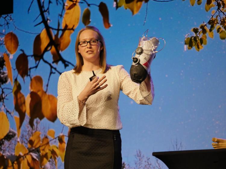 Madalyn Kern (MechEngr’12; MS’14; PhD’16) holds up a prototype of an adjustable-fit prosthetic leg that she is designing and manufacturing during her talk. Photo by Glenn Asakawa.