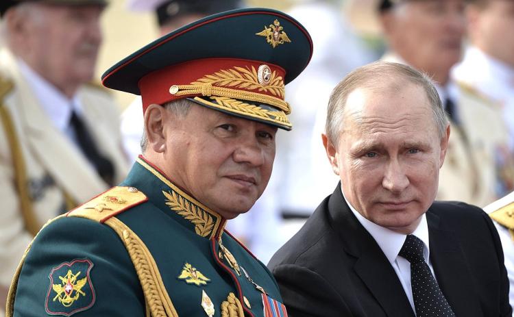 Vladimir Putin sits next to Sergei Shoigu