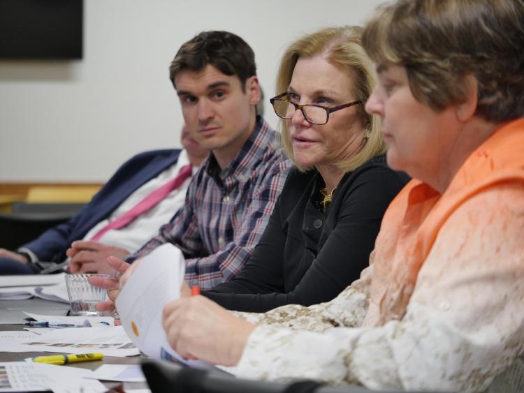Business ethics competition judges ask questions from student competitors. Photo by Glenn Asakawa.