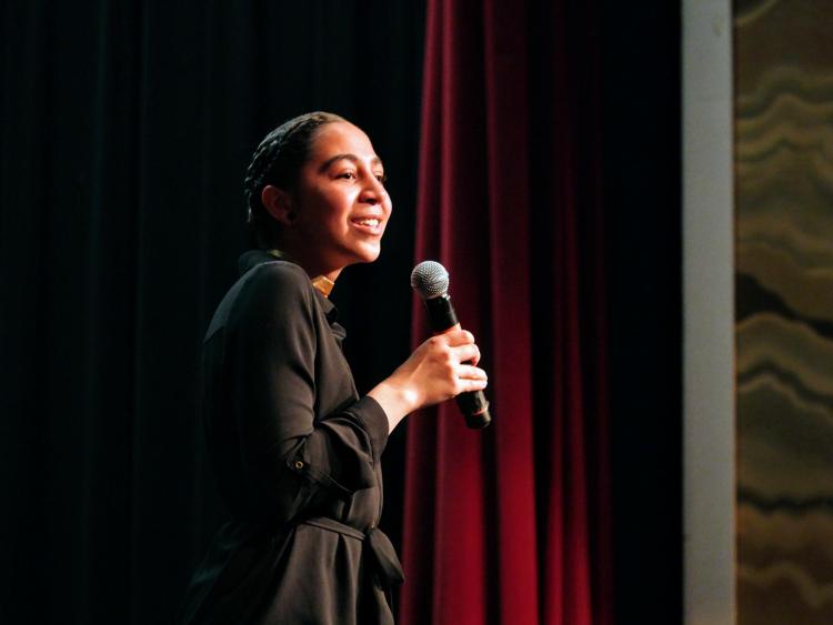 CU Boulder student Gwendalynn Roebke serves as emcee. Photo by Glenn Asakawa.