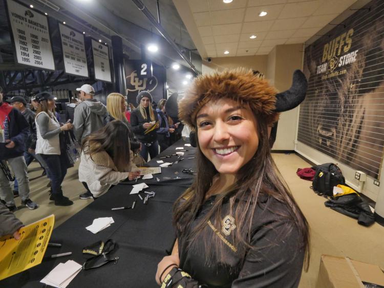 Friendly CU admissions staff hand out swag and help admitted students and their parents at Coors Events Center. Photo by Glenn Asakawa.