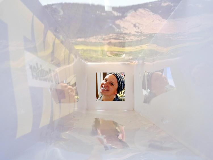 Rebecca Reifel, Alumni Association senior chapters manager, looks through a display piece at CU Boulder Next Washington, D.C. Photo by Glenn Asakawa.