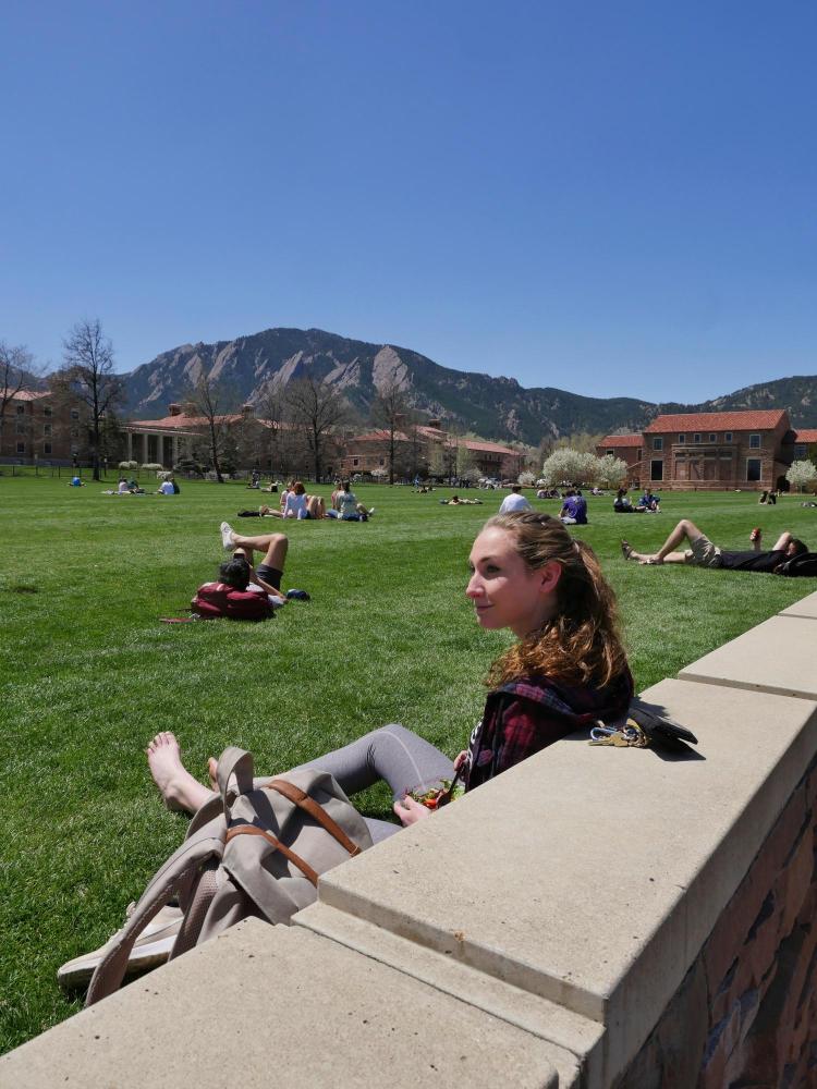Cora Bradley, a junior chemical and biological engineering major from Annapolis, MD, enjoys the sun and warmth at Farrand Field. Photo by Glenn Asakawa.