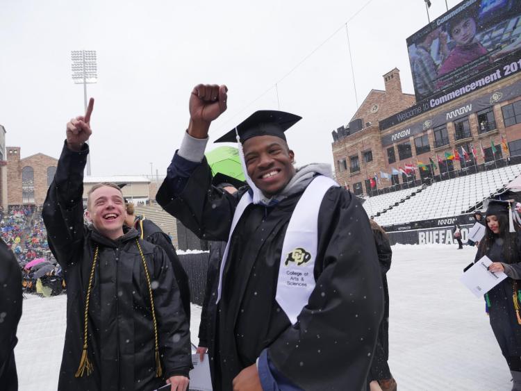 Graduates making their way to their seats on Folsom Field