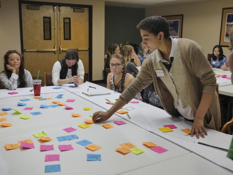 Participants work with sticky notes during a Diversity and Inclusion Summit session