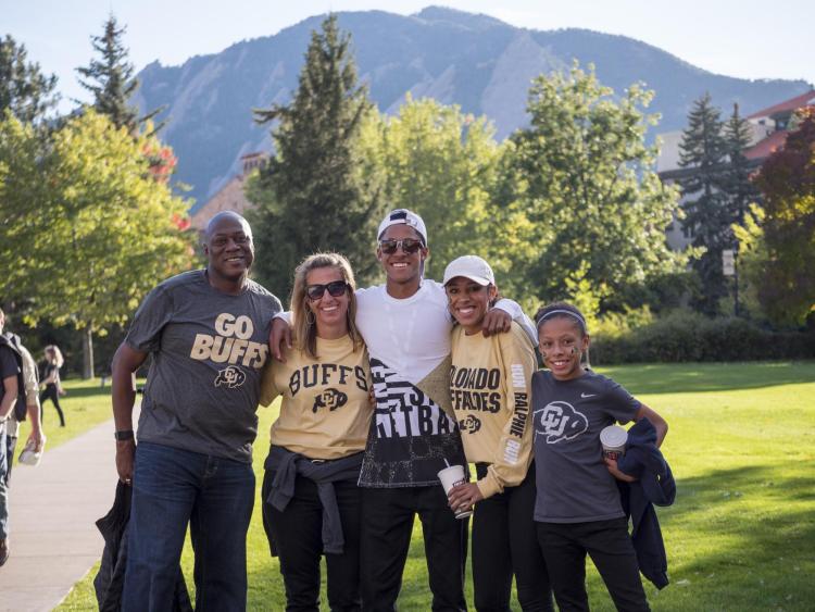 Family poses for photo on campus during annual Family Weekend