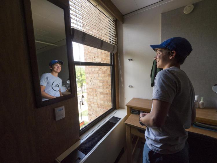 Student looks out window during move-in