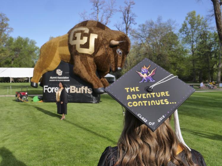 Student graduation cap reading 'The adventure continues'