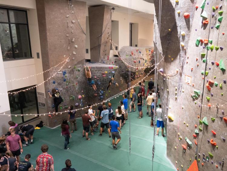 Students hang out by the climbing wall during Connect at The Rec