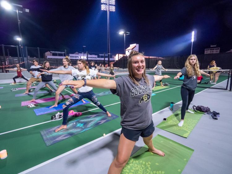 Students participating in a rooftop yoga class