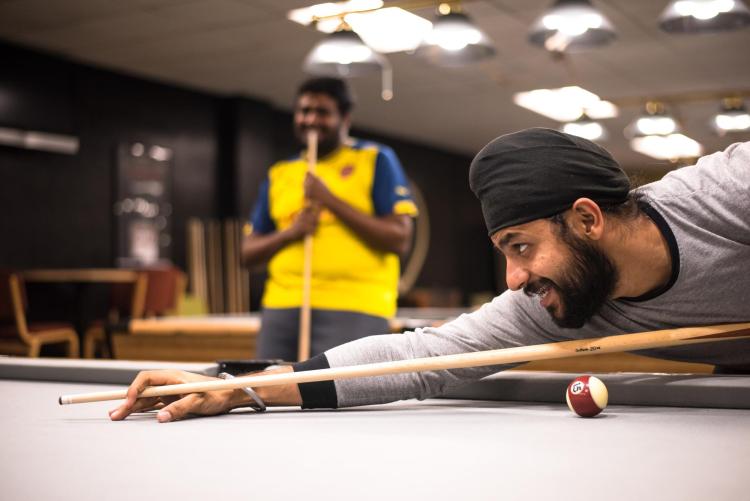 students playing billiards in The Connection
