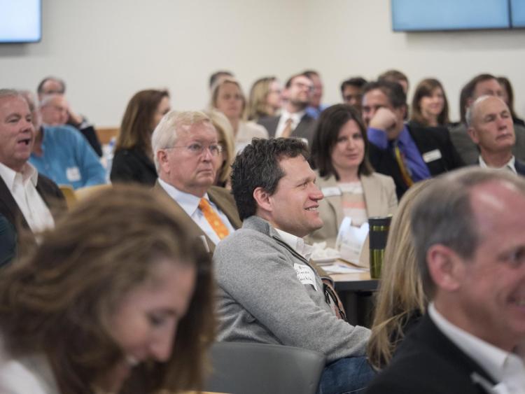 Attendees listen to student presentations at the Leeds Center Showcase. Photo by Glenn Asakawa.