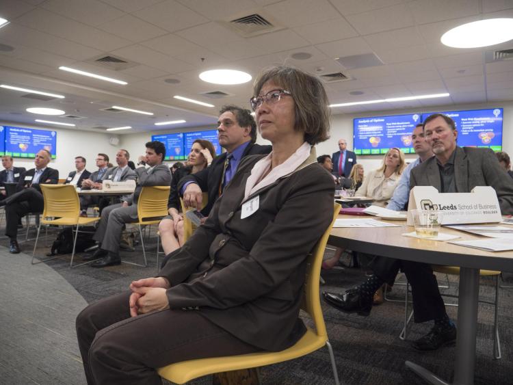 Attendees listen to student presentations at the Leeds Center Showcase. Photo by Glenn Asakawa.