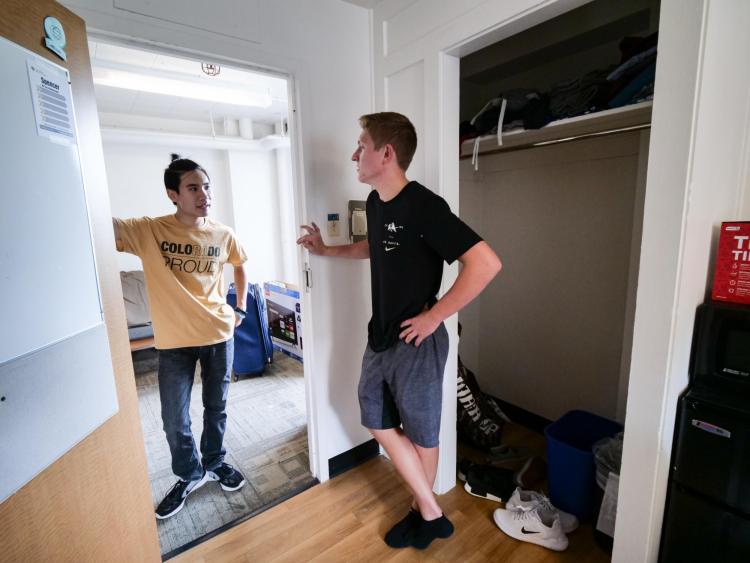Student chats with RA outside of dorm room