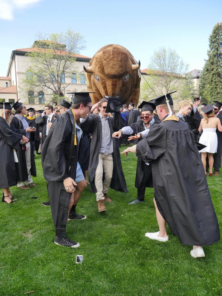 Grads gather at Norlin Quad before the main commencement ceremony. Photo by Glenn Asakawa.