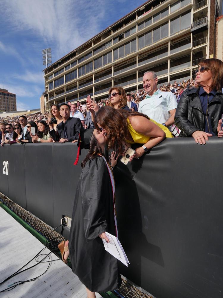 Meghan Bille, advertising, kisses her mom, Bernadette, before the commencement ceremony. Photo by Glenn Asakawa.