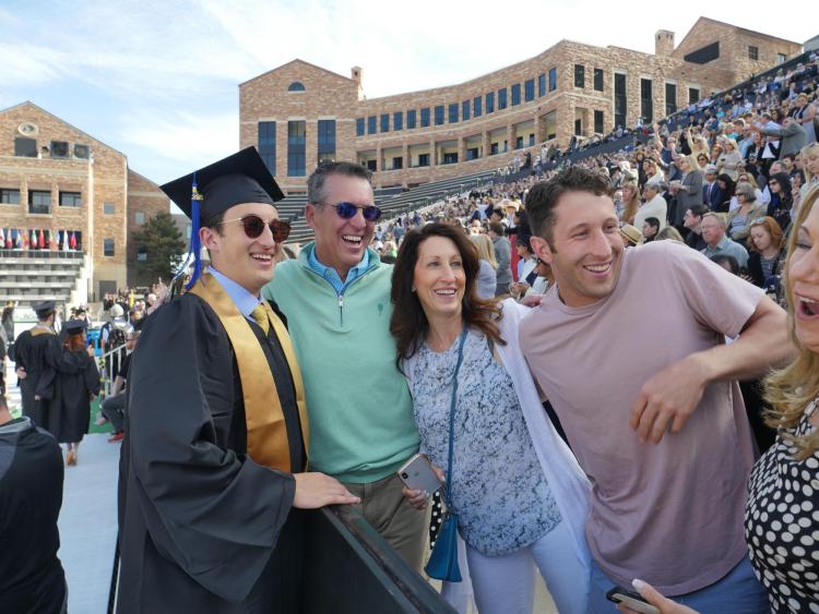Family members catch a view of their graduate before the commencement ceremony. Photo by Glenn Asakawa.