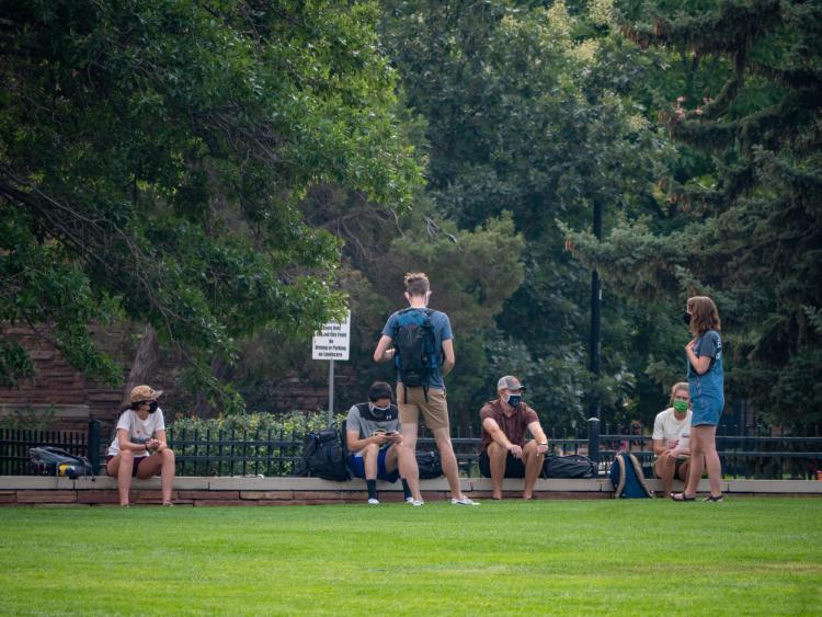 students outside in a group of six people