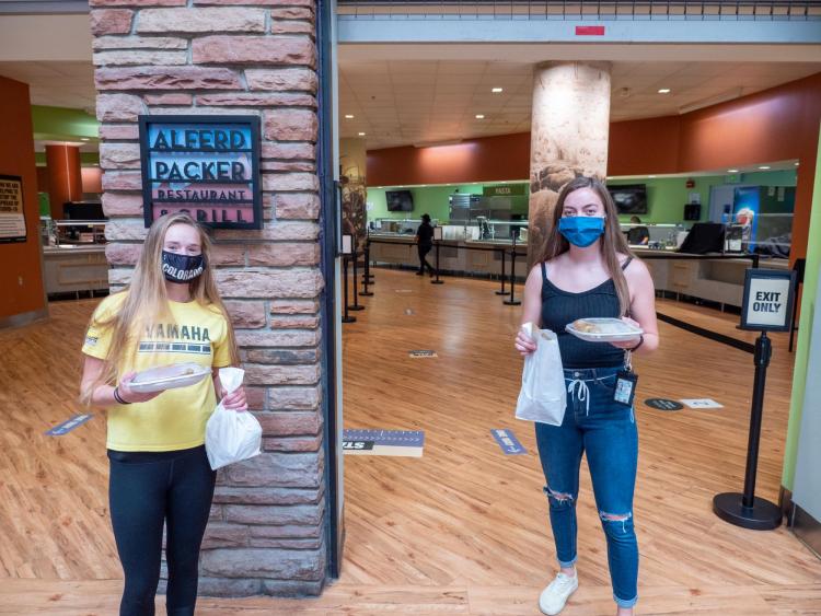 Students carry out the meals they ordered at the Alferd Packer Grill.