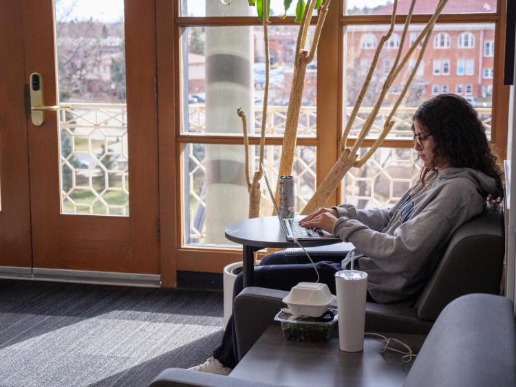 A student studies on the 5th floor of the UMC