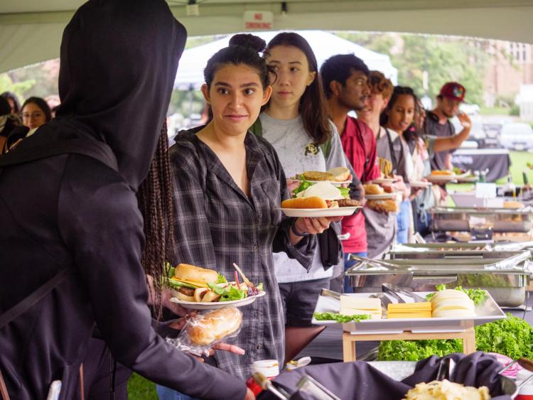 Students make plates of food in a buffet line during CUnity Fest
