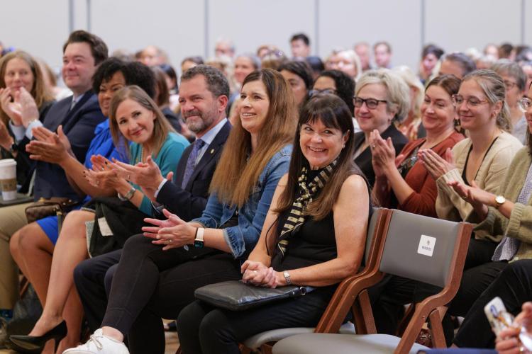 A crowd of seated people listen to the 2023 State of the Campus address.