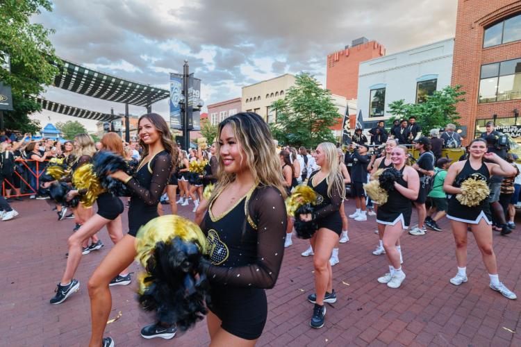 Cheerleaders on Pearl Street Mall during the first Stampede