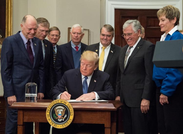 Schmitt joins fellow astronaut Peggy Whitson as President Trump signs a directive instructing NASA to return to the moon