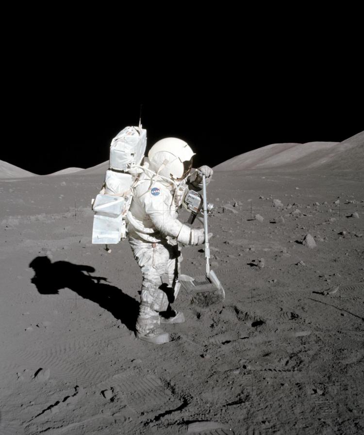 Harrison Schmitt collects geologic samples from the surface of the moon using a "lunar rake."