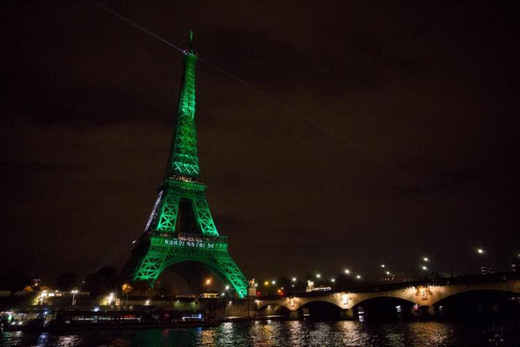 Eiffel Tower in Paris illuminated green in celebration of Paris Agreement