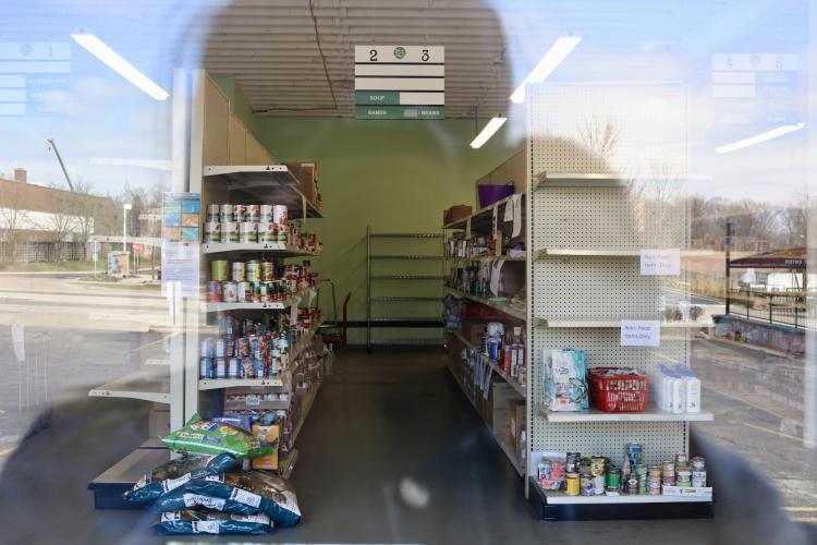 Student takes a photo of a vacant store through the window