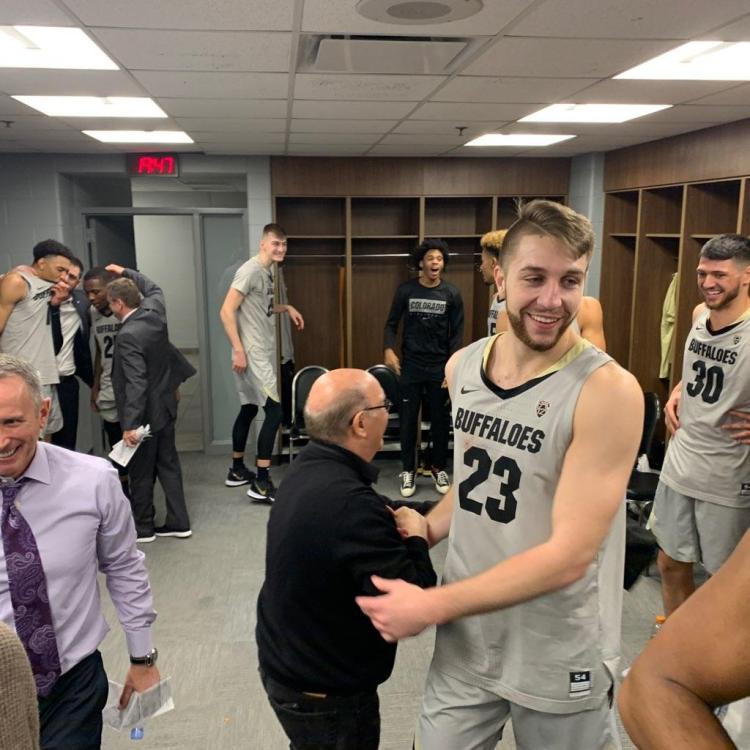 CU Boulder Chancellor Philip DiStefano meets with Colorado men's basketball players following the team's win over Dayton.
