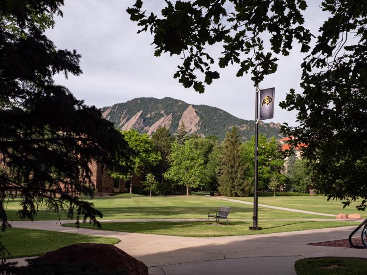 A view of the Flatirons from a quiet CU Boulder campus.