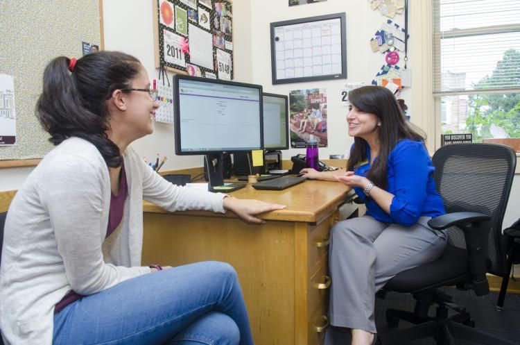 Academic advisor speaks with a student in her office