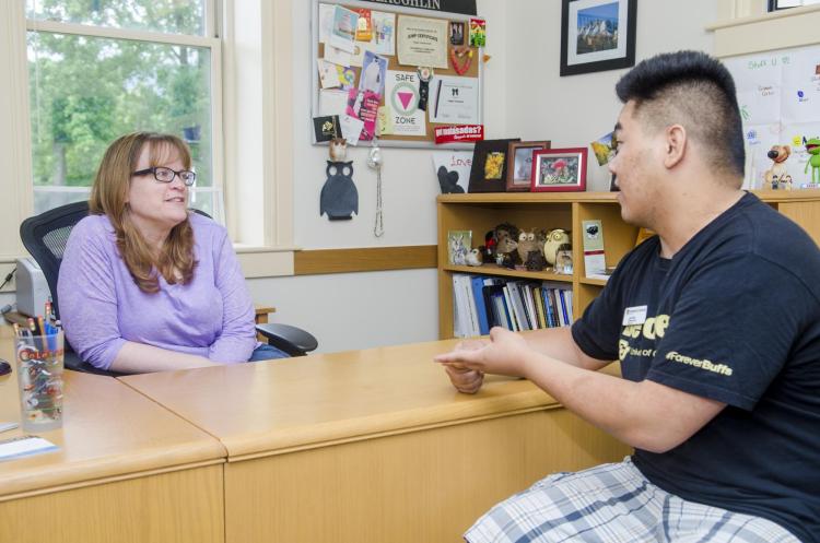 Student talking with advisor.