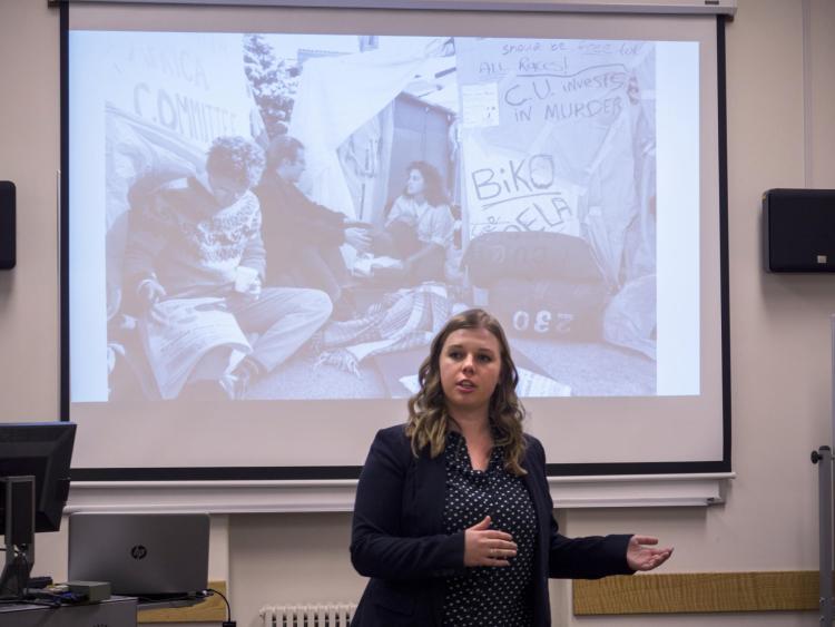 Graduate student Claire Steffen provides an overview to student social activism exhibit visitors. Photo by Glenn Asakawa.