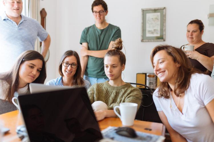 student surrounded by family members