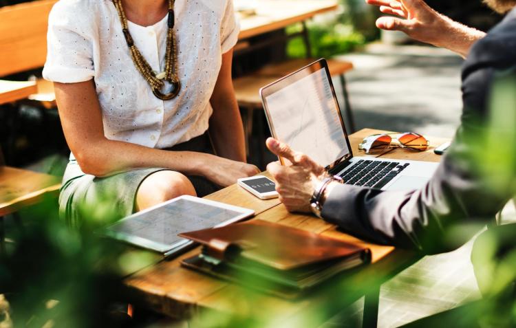 Stock photo of a woman talking to a man at work.