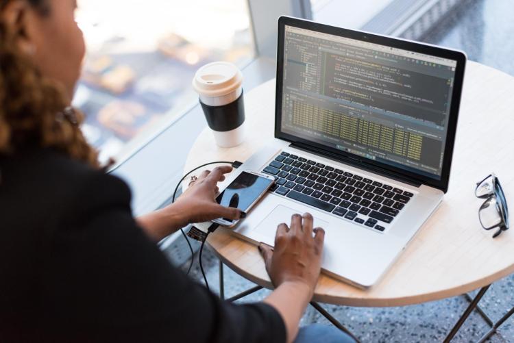 Person coding on laptop computer