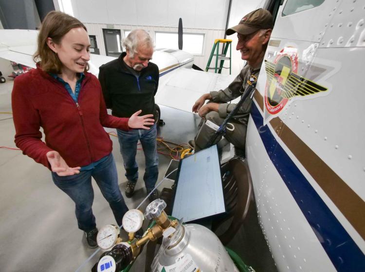 Abigail Koss, Alan Fried and Nizar Bechara in a hangar