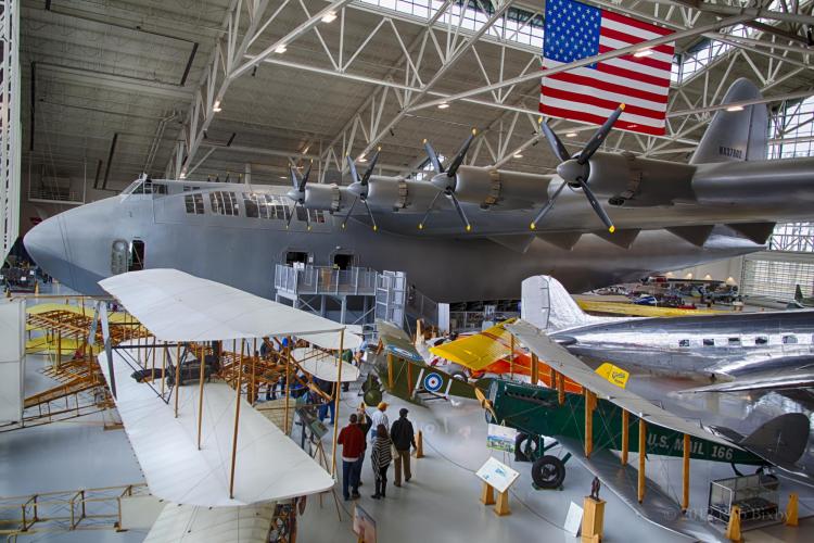 Visitors look at planes at the Wings Over the Rockies Air and Space Museum
