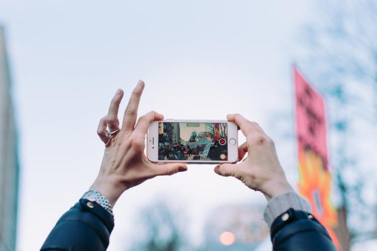 Cell phone being used in public to record a protest