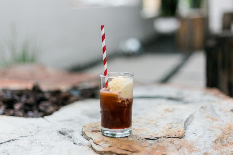 root beer float with ice cream and a red striped paper straw