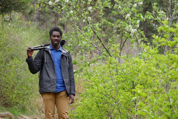 Ani Yahzid with his camera outdoors