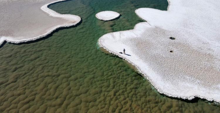 Aerial view of a lagoon surrounded by salt flats