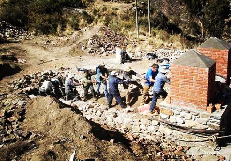CU Boulder students construct the base for a suspension bridge